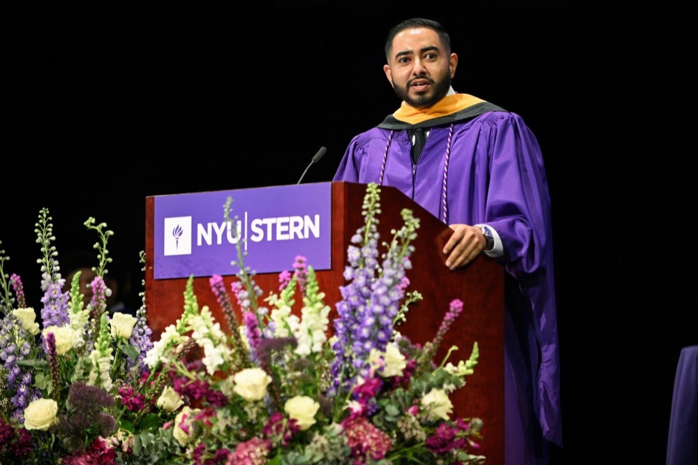 Abe Varughese speaking at the NYU Stern podium